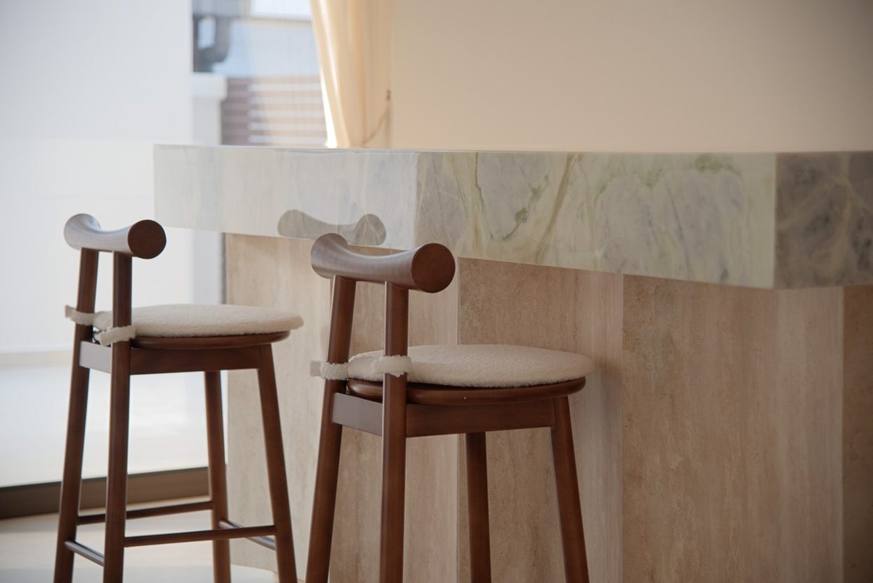 Timber bar stools against the finished stone island
