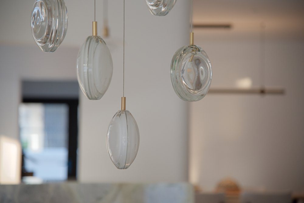 Hand-blown glass pendants on brass fittings, close